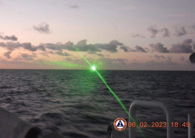 A green light appears from the direction of a Chinese coast guard ship at the Second Thomas Shoal, 105 nautical miles off the Palawan Province, Philippines, February 6, 2023 in this handout image. PHOTO: Reuters